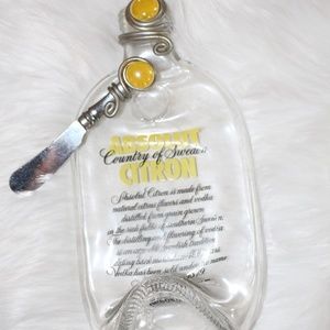 Absolut Citron Vodka bottle , melted flattened bottle with cheese knife